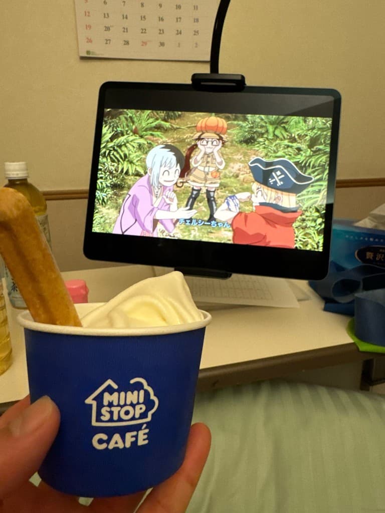 Soft-serve ice cream and anime on a tablet in the hospital room